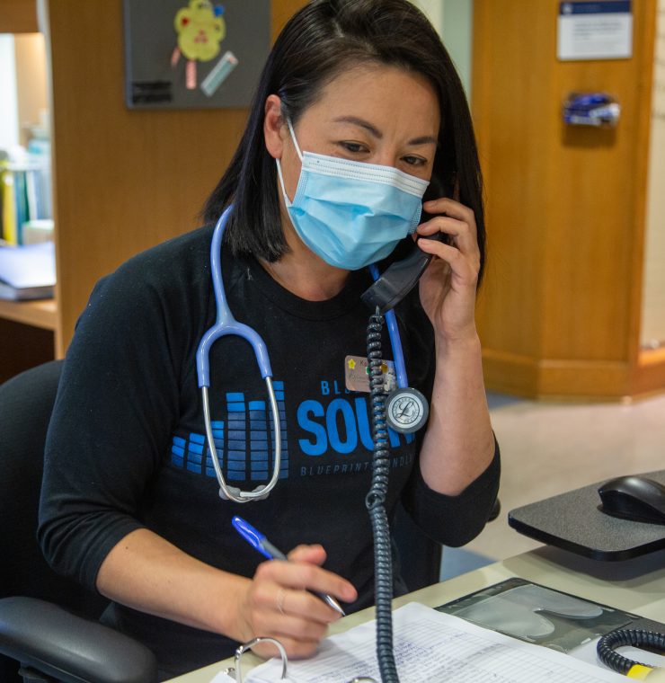 Canuck Place Nurse on phone to answer the 24-Hour Clinical Care Line