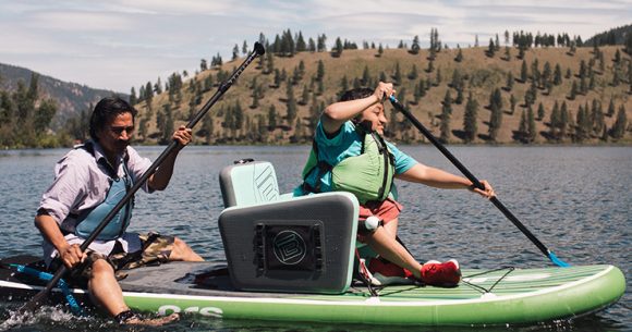 Canuck Place recreation therapy activity with a family paddle boarding on a lake