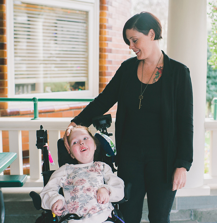 Canuck Place mom with her child at Canuck Place Children's Hospice front porch