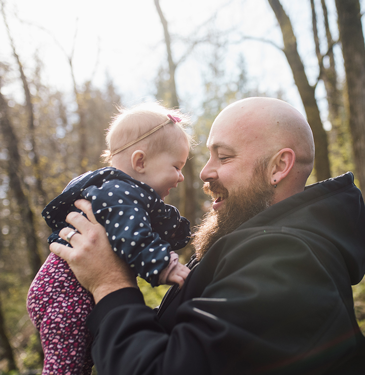 Canuck Place father playing with his child outdoors in the sunshine
