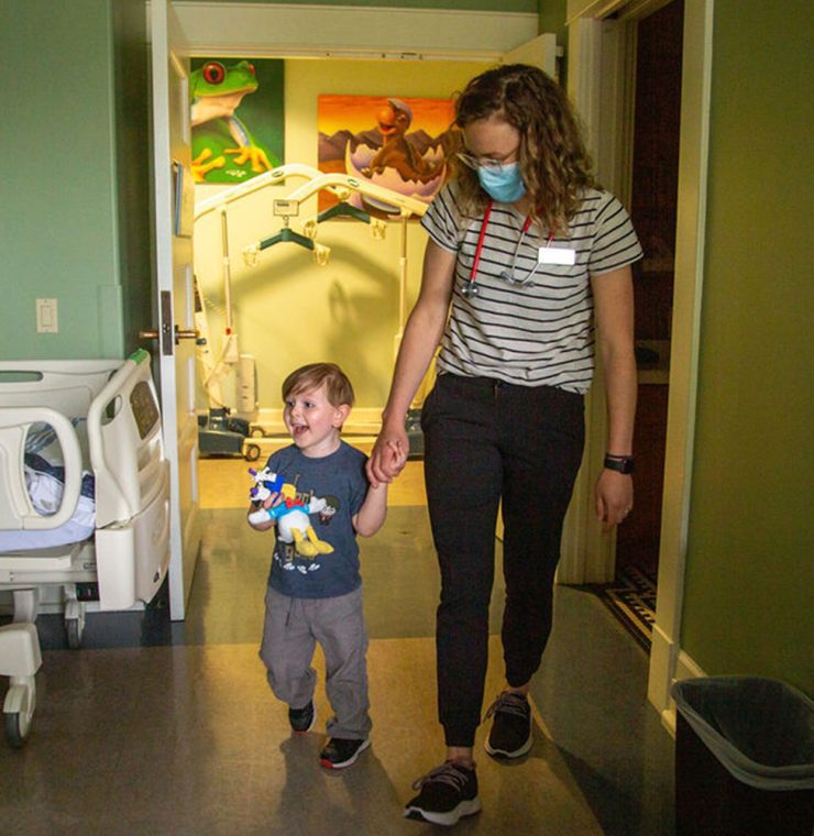 Nurse and child walking in suite at Canuck Place Children's Hospice
