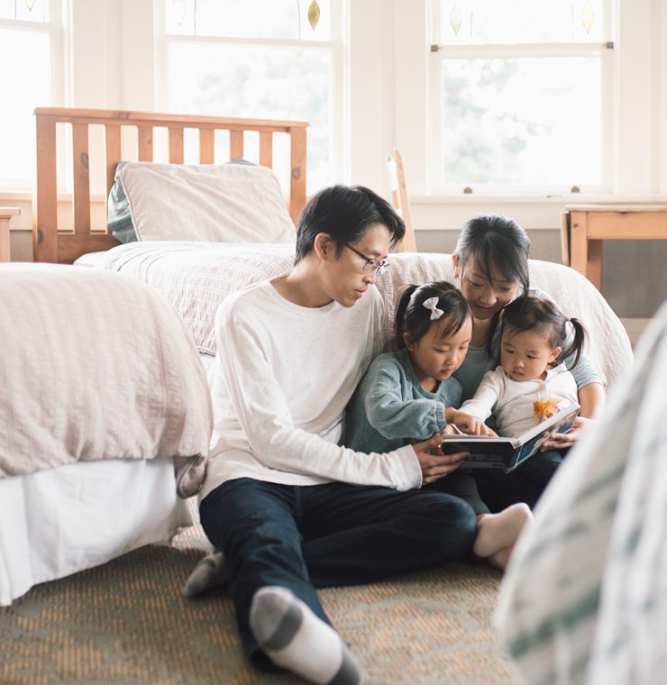 Canuck Place family in family suite at Canuck Place Children's Hospice reading together