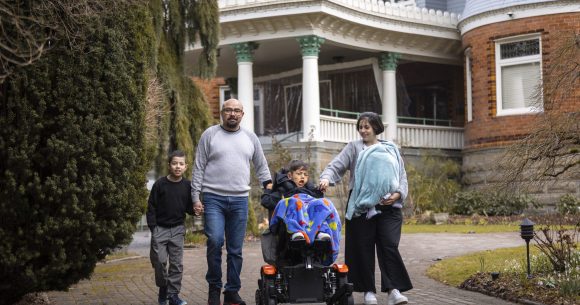 Canuck Place family in front of Canuck Place Vancouver - Glen Brae Manor