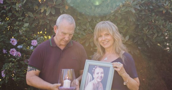 The Hall family holding a photo of their daughter Lily at Canuck Place Children's Hospice